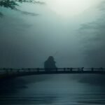 Cinematic wuxia fantasy scene with a swordsman on a misty bamboo bridge, evoking C-drama fantasy dramas like The Untamed
